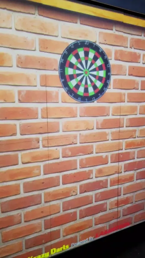Traditional dartboard mode on brick-wall background